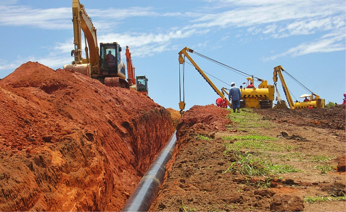 A pipeline being installed on the side of a hill.