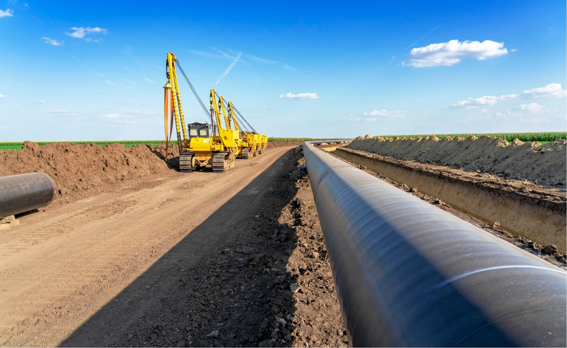 A pipeline laying in the middle of a road.